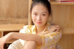 Sexy photo of beauty with slender legs in warm yellow shirt