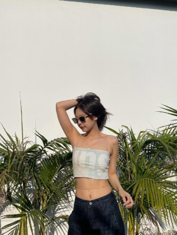 Sexy photo of JENNIE wearing sunglasses and touching breasts