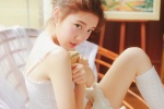 Seductive photo of beautiful lady in white silk stockings with sexy legs