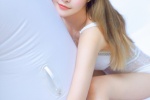 Photo of beauty with long legs in low-cut suspender swimsuit