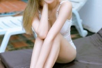 Photo of beauty with long legs in low-cut suspender swimsuit