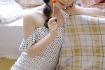 Seductive photo of beauty in polka dot dress with suspenders and long legs