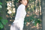 Outdoor photo of intellectual beauty in sexy low-cut long skirt