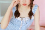 Photo of playful ponytail beauty in sexy suspender skirt