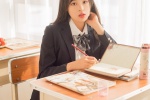 Seductive photo of beautiful school girl at desk in JK uniform