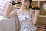 Seductive photo of beauty in polka dot dress with suspenders and long legs