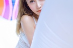 Photo of beauty with long legs in low-cut suspender swimsuit