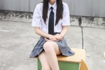 Photos of pure and beautiful school girls in uniforms on rooftop desks