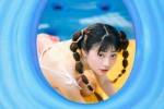 Cute and playful photo of girl with playful ponytail in amusement park
