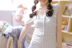 Seductive photo of beauty in polka dot dress with suspenders and long legs