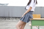 Photos of pure and beautiful school girls in uniforms on rooftop desks