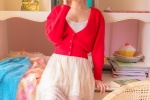 Photo of sexy pretty girl in red cardigan and low-cut suspender belt