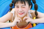Cute and playful photo of girl with playful ponytail in amusement park