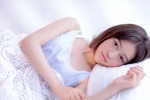 Sexy photo of short-haired beauty in vest and pajamas on bed