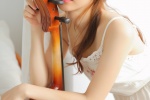 Elegant and sexy artistic photo of beautiful cello player