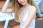 Photo of beauty with long legs in low-cut suspender swimsuit