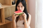 Japanese photography photo of a beautiful lady eating watermelon