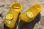 Crocs joint smiley face shoes displayed from multiple angles