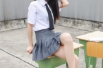 Photos of pure and beautiful school girls in uniforms on rooftop desks