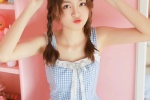 Photo of playful ponytail beauty in sexy suspender skirt