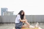 Photos of pure and beautiful school girls in uniforms on rooftop desks