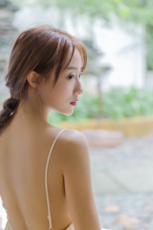 Sexy photo of beautiful woman in backless suspender dress