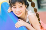 Cute and playful photo of girl with playful ponytail in amusement park