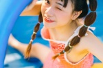 Cute and playful photo of girl with playful ponytail in amusement park