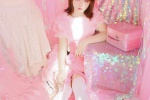 Eye-catching and charming young lady with white stockings and beautiful legs in pink photo