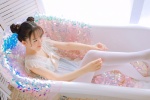 Playful and sexy photo of beauty in bathtub with white stockings and Nezha head