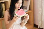Japanese photography photo of a beautiful lady eating watermelon