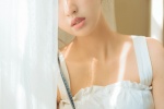 Sexy photo of a beautiful girl with round head and exposed shoulders
