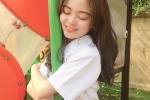 Beautiful girl in amusement park, sexy girl in miniskirt and uniform