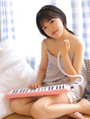 Seductive and sexy photo of beauty with electronic piano and suspender pajamas