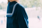 Seductive photo of college style beauty in navy uniform