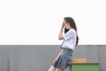 Photos of pure and beautiful school girls in uniforms on rooftop desks