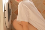 Beautiful photo of short-haired beauty next to washing machine