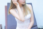 Photo of beauty with long legs in low-cut suspender swimsuit