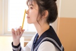 Seductive photo of a beautiful schoolgirl with oval face and navy uniform