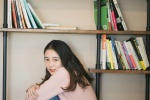 Shy and sweet photo of a beautiful student girl in the study room