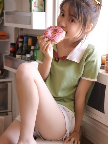 Photo of energetic girl with sexy legs next to the refrigerator