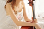 Elegant and sexy artistic photo of beautiful cello player