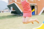 Cute and playful photo of girl with playful ponytail in amusement park