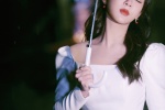 Photos of Yang Zi walking on the street with a beautiful umbrella at night